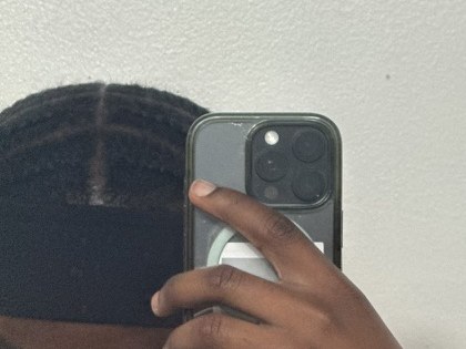Braided hair with parted rows, seen in a mirror selfie